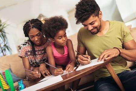 107132886--mom-and-dad-drawing-with-their-daughter-african-american-family-spending-time-together-at-home-